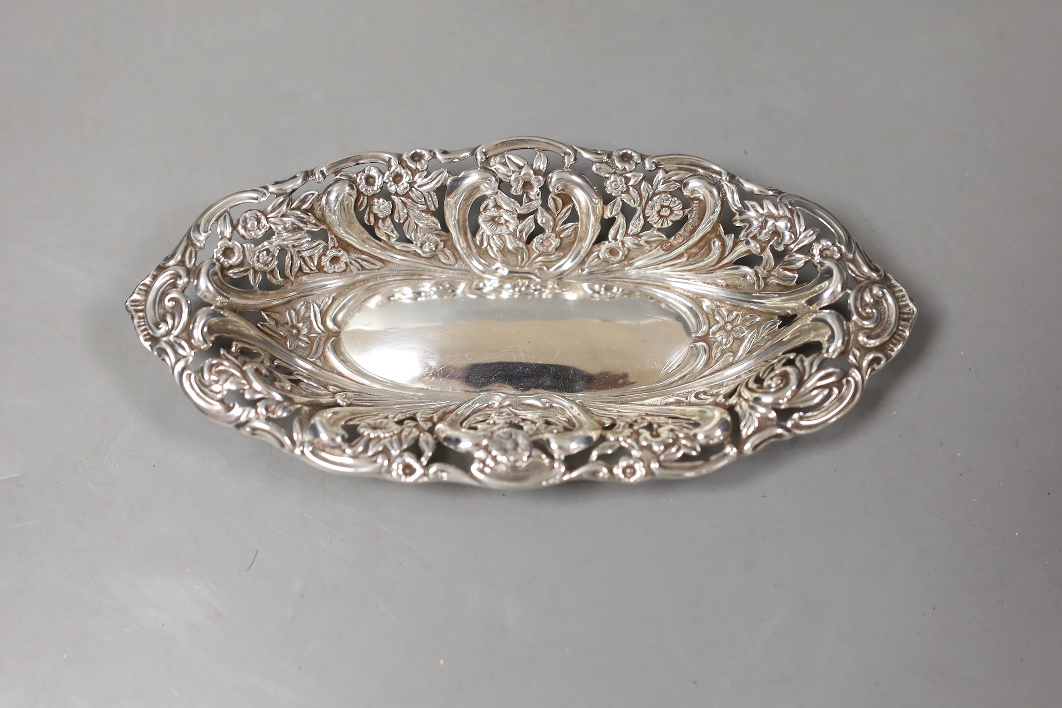 A late Victorian silver oval pedestal dish, James Deakin & Sons, Chester, 1894, 22cm and a similar repousse silver bonbon dish, 6.5oz.